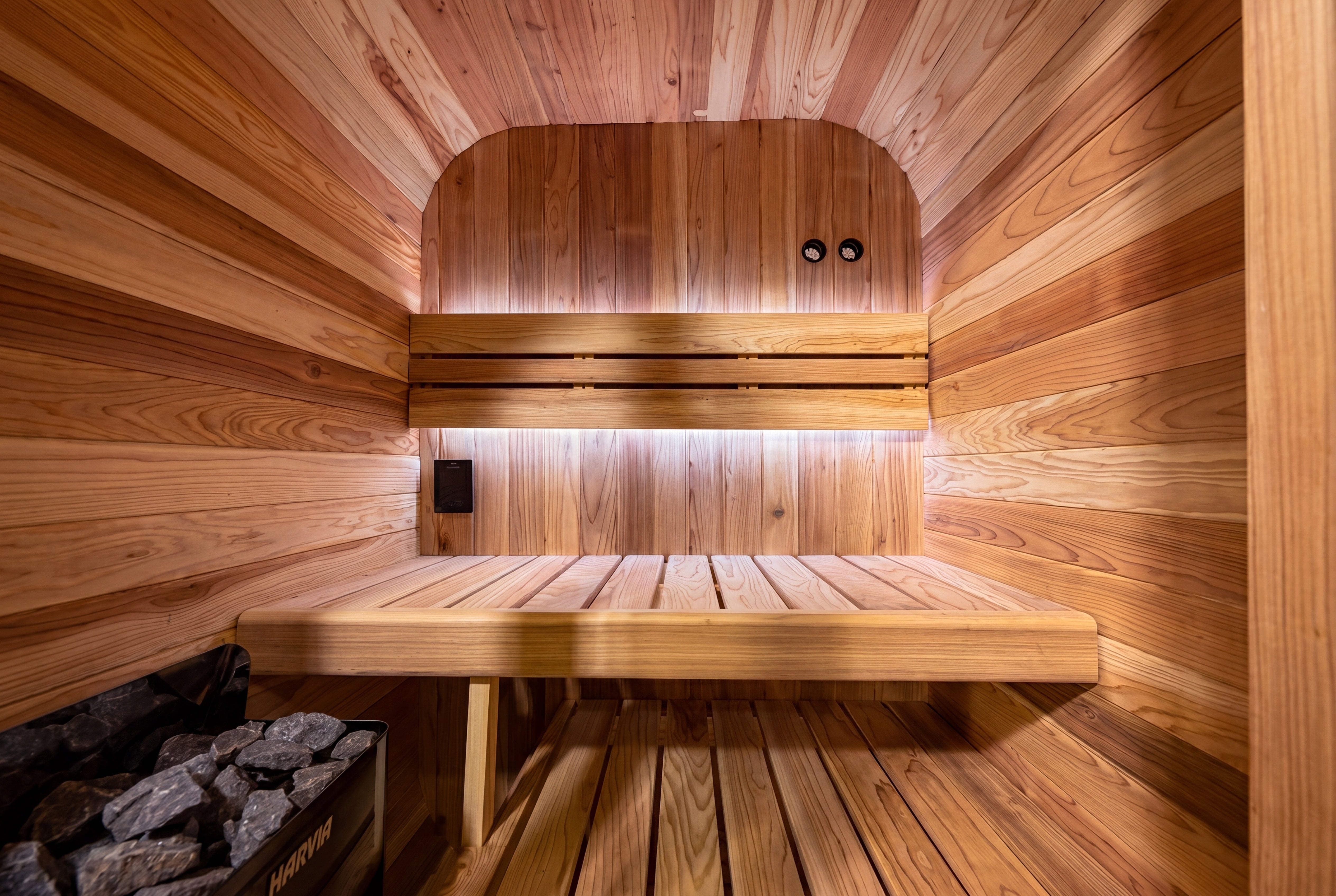 Cedar Cube 2 outdoor sauna interior with cedar bench and traditional Harvia heater