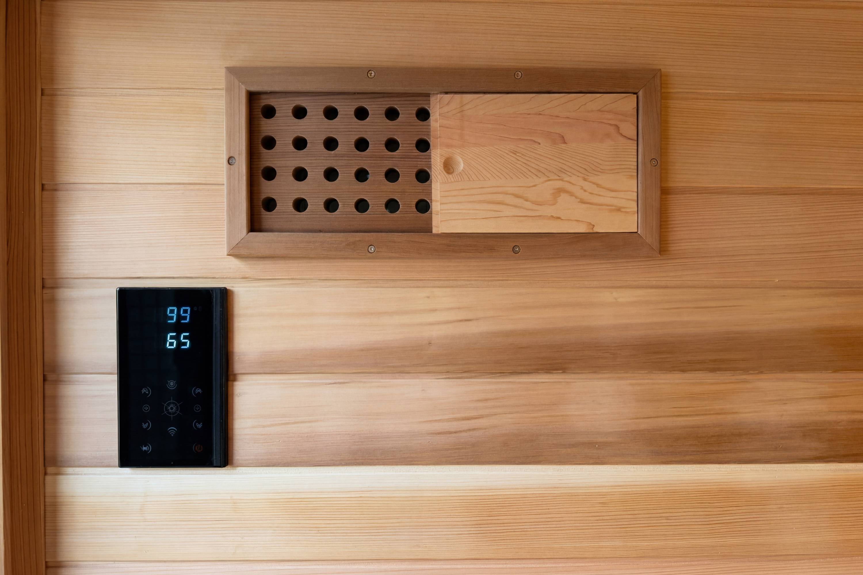 Swell Black Eco 4 sauna control panel and ventilation detail on cedar interior wall