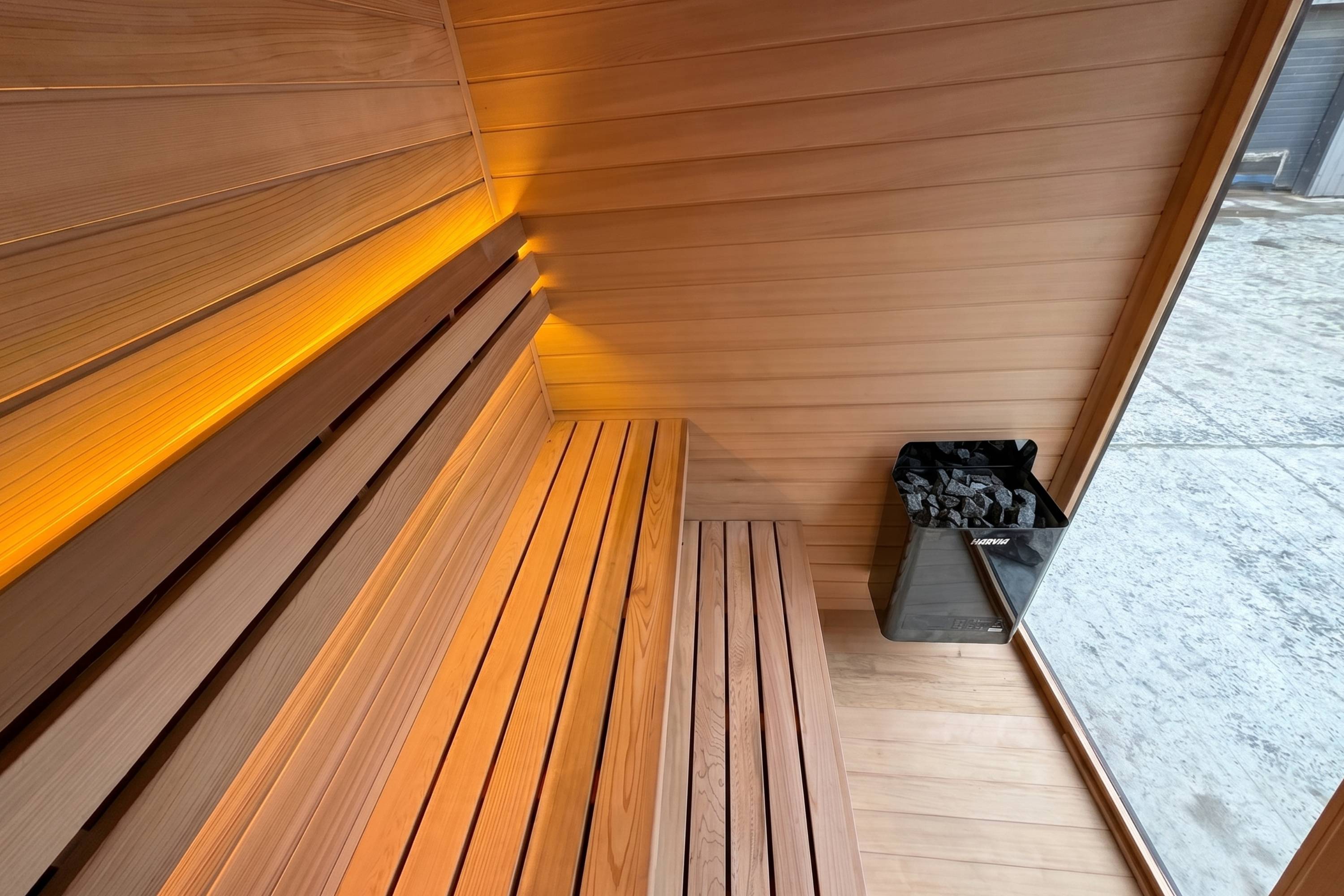 Overhead view of cedar sauna benches and Harvia heater inside Swell Black Eco 4