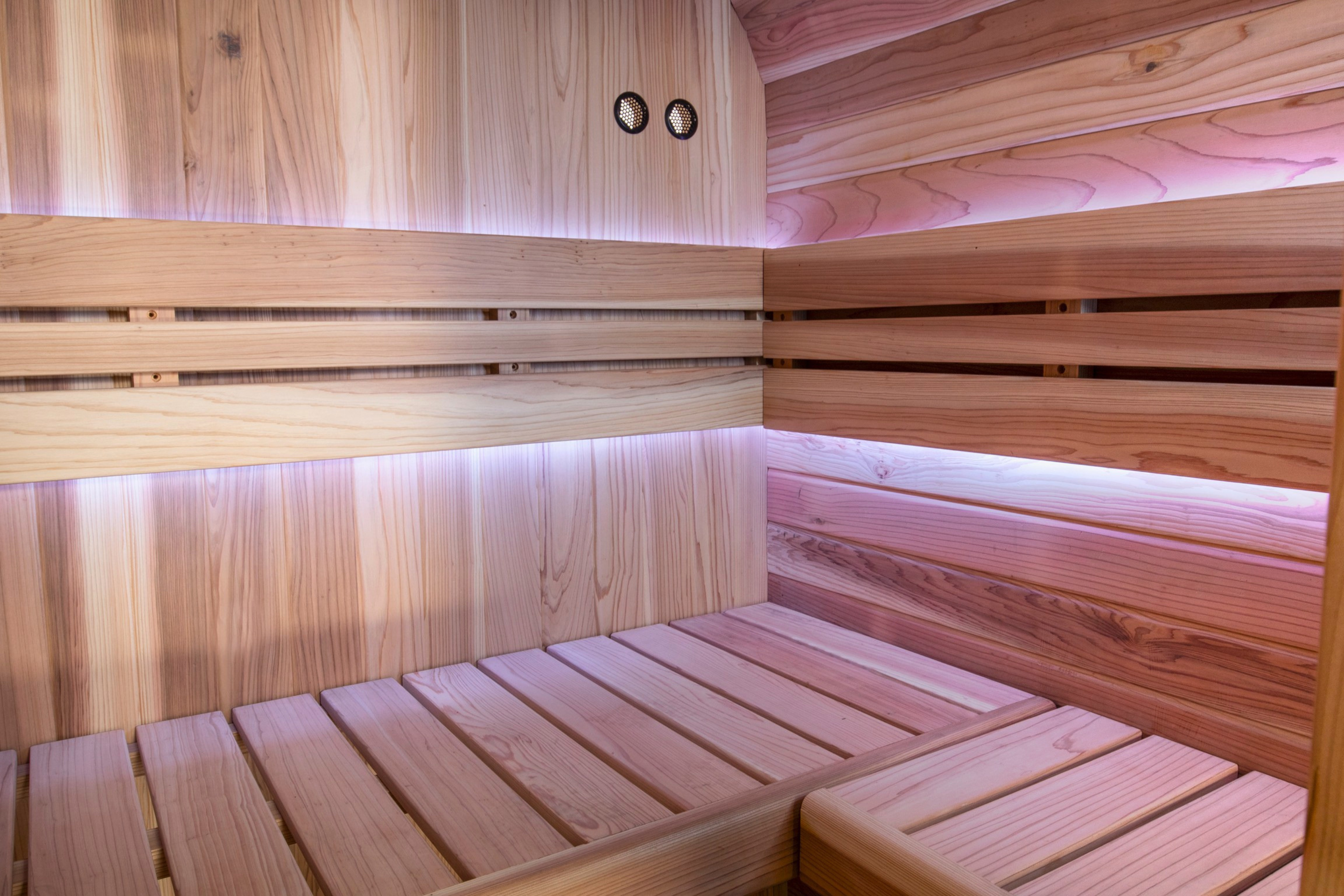 Corner view of Swell Cedar Cube 4 timber benches and illuminated backrests