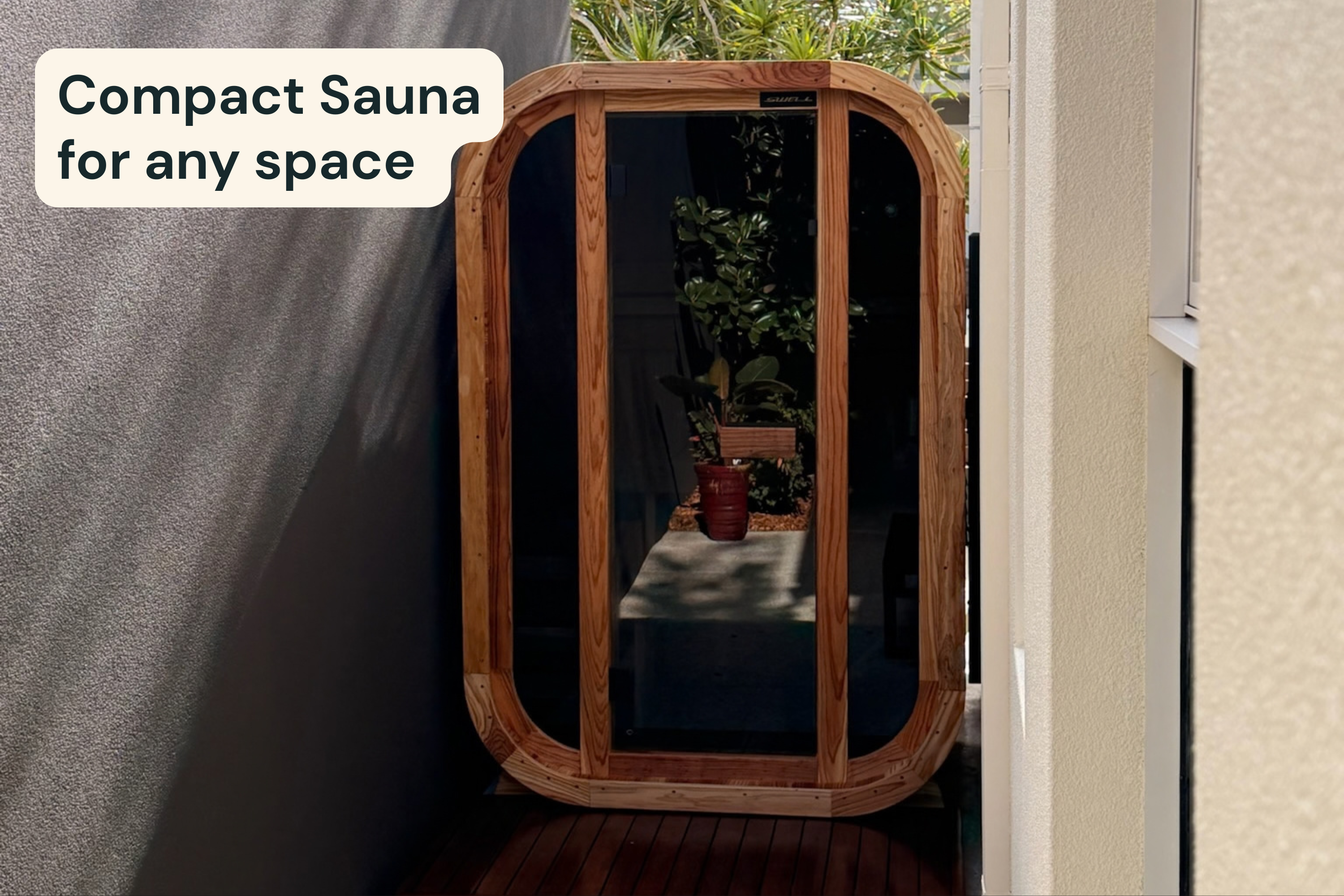 Swell Cedar Cube 2 compact outdoor sauna positioned in a narrow courtyard